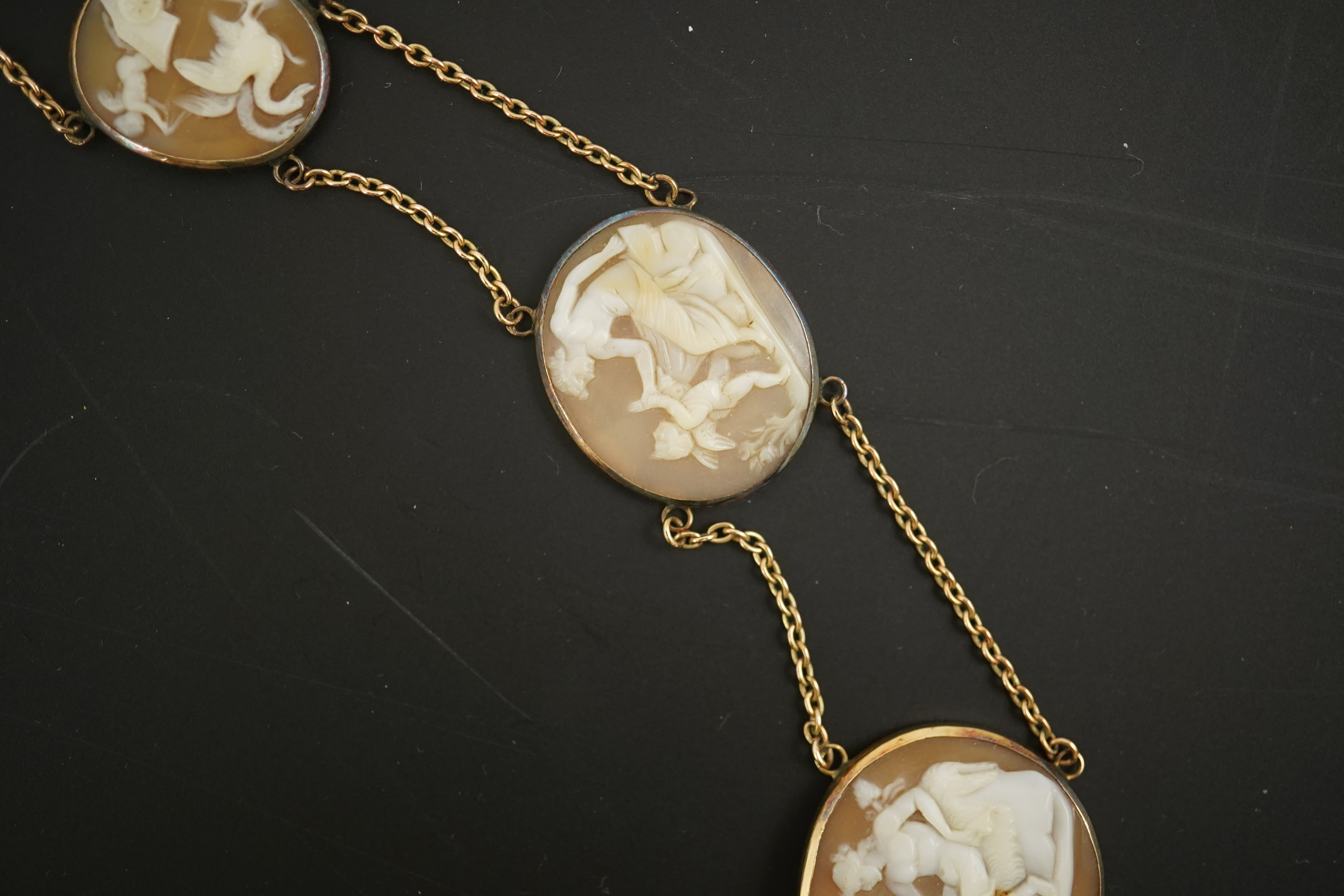 An early 19th century Italian Grand Tour gold double chain link and ten graduated oval cameo shell set necklace